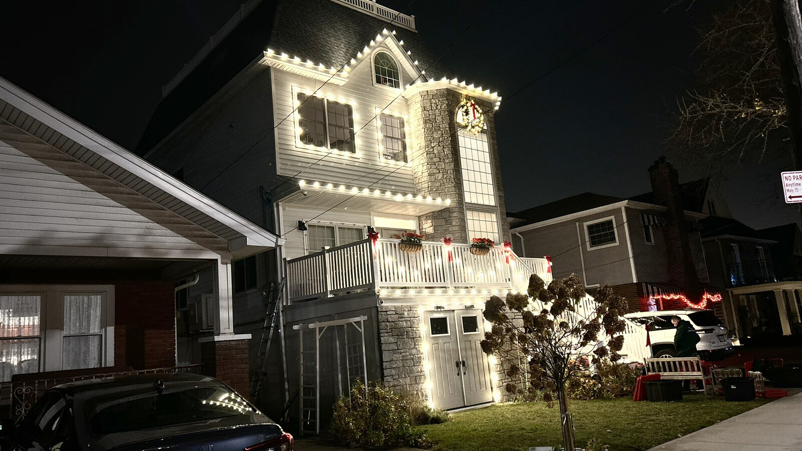 A home and street beautifully lit for Christmas at night